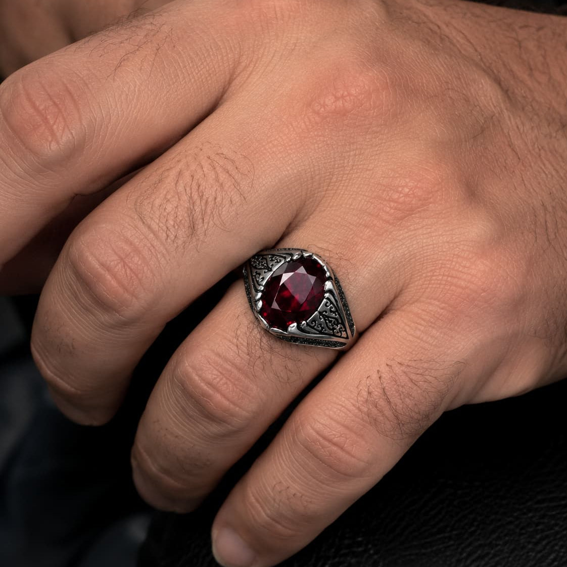Bague du Commandeur en argent 925 sterling avec pierre rouge portée à la main par un homme