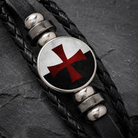 Gros plan de la croix rouge du Bracelet Croix du Temple en cuir tressé noir et alliage métallique premium