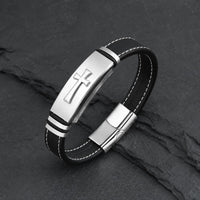 Bracelet de la Croix Sacrée en cuir véritable noir et acier inoxydable argenté sur fond anthracite texturé