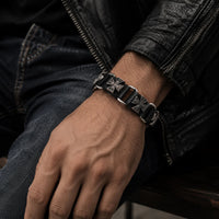 Bracelet du Veilleur Templier porté par un homme avec veste sombre, cuir noir et jean brut