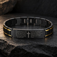 Bracelet du Pater Noster Sacré en acier noir et or avec gravure latine et croix sur fond minéral sombre