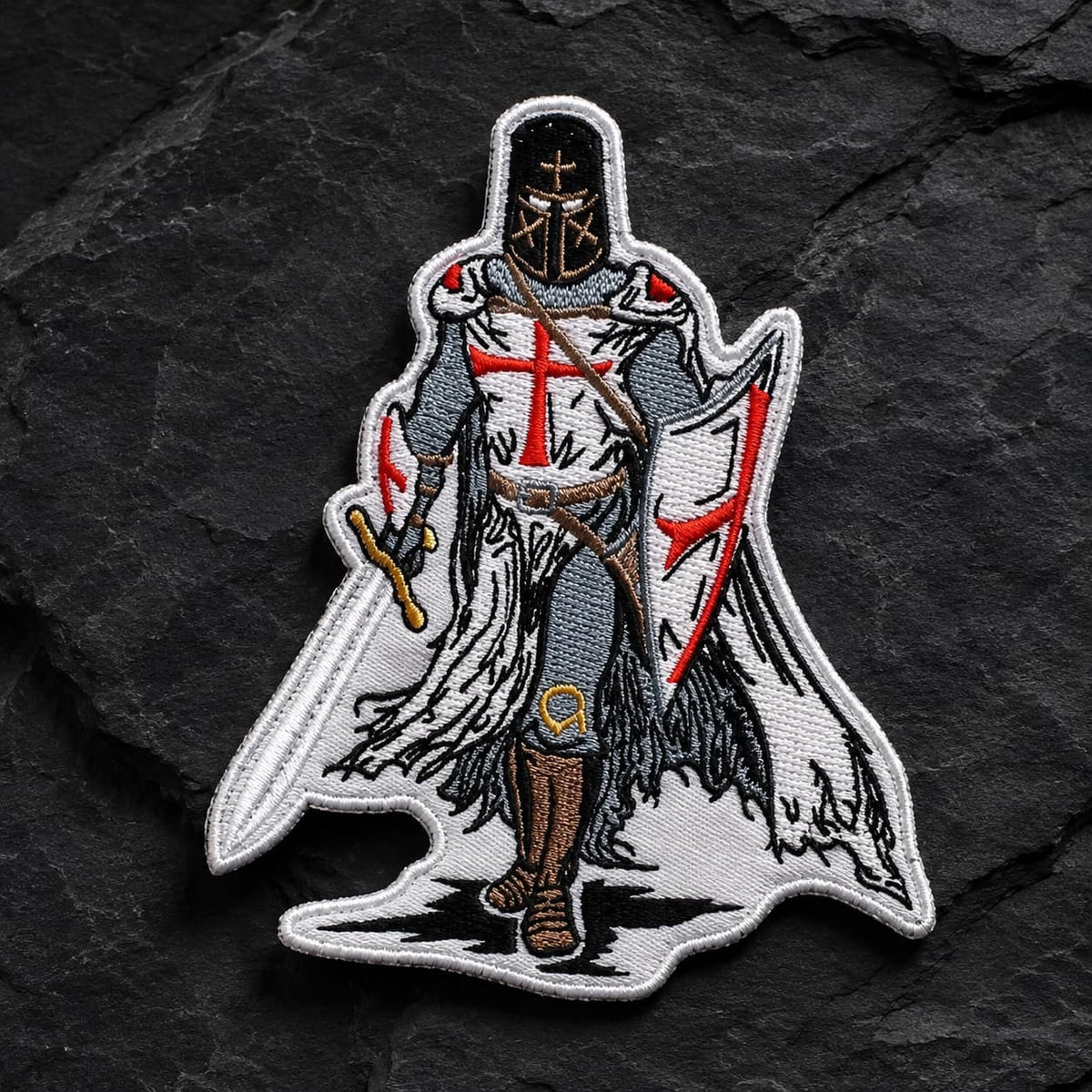 Écusson Chevalier Templier en tissu brodé présenté de face sur fond d’ardoise sombre.