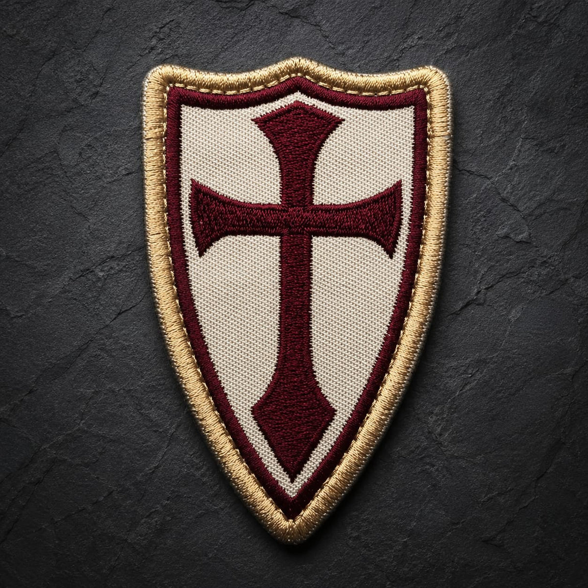 Patch Écusson de la Lance du Templier en tissu brodé avec croix bordeaux et bordure dorée sur fond ardoise sombre.