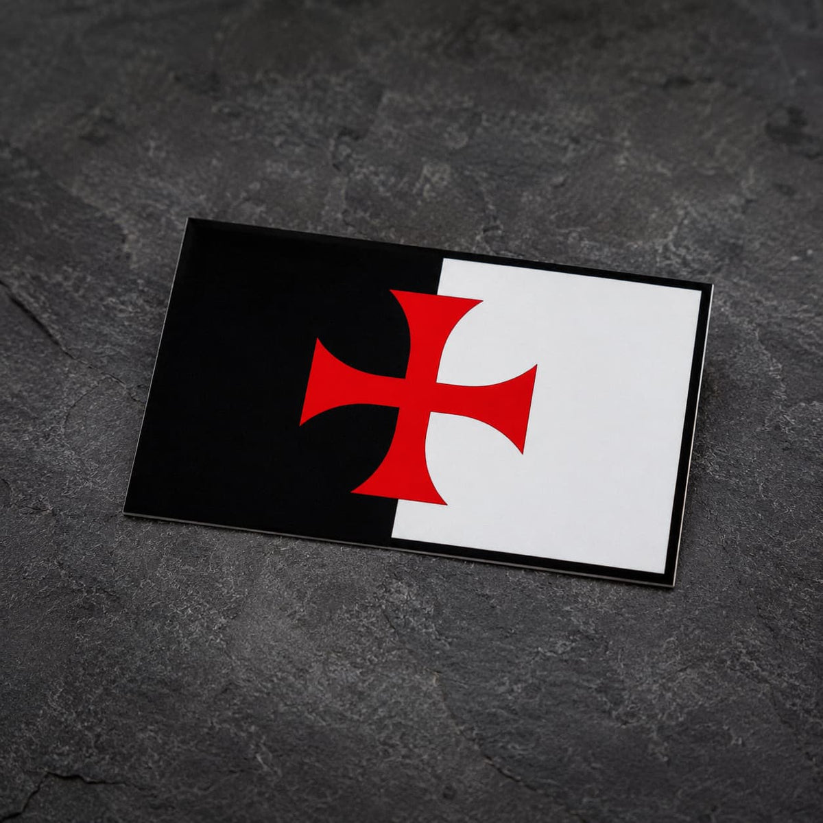 Sticker Bannière du Temple en vinyle présenté en vue inclinée sur fond ardoise sombre.