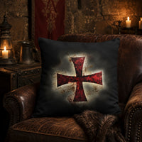 Taie d’Oreiller Croix Templier en polyester posée sur un fauteuil en cuir dans une ambiance médiévale.